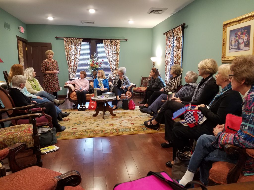 A docent hosting a guided tour inside the Blind Boone Home
